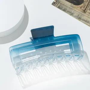 Detailed close-up of blue gradient rectangular hair claw clip with semi-transparent finish