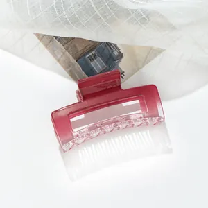 Detail of square gradient berry red acrylic hair claw clip with transparent finish
