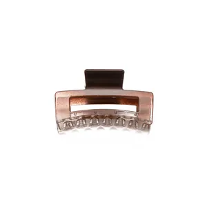 Macro view of a square amber resin hair claw clip with transparent texture and glitter finish