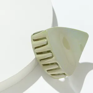 Sparkling cat ear hair claw clip in pistachio green on white circular display