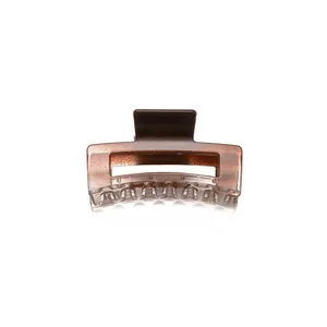 Minimalist square hair claw clip in translucent amber resin with rectangular hollow design