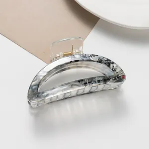 Macro view of Chinese ink style acetate hair claw with elegant black calligraphy patterns