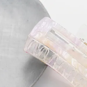 Rectangular acetate hair claw clip with lavender pearlescent texture and high gloss finish