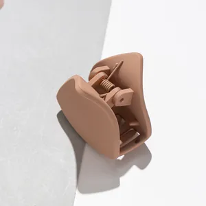 Macro detail of nude matte cat ear hair claw clip with durable metal spring and teeth
