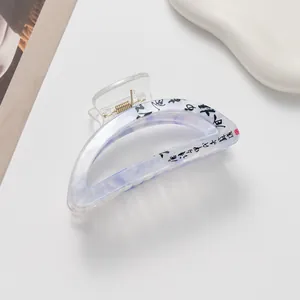 Close-up of a blue and white marble pattern hair claw clip with Chinese calligraphy