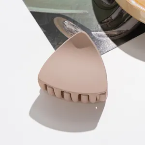 Close-up of matte nude cat-ear hair claw clip with interlocking teeth for daily styling