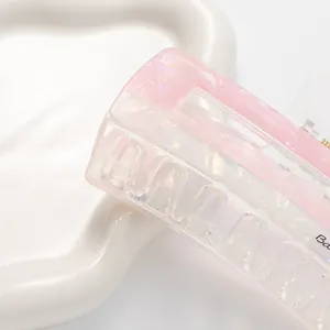 Macro view of pink marble acetate large hair claw clip with strong metal spring detail