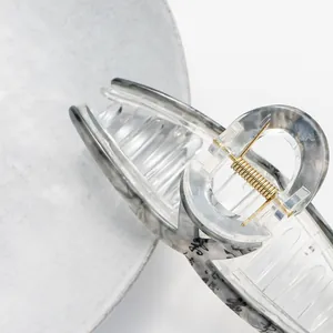Macro detail of 13cm hair claw clip with ink calligraphy pattern and gold spring