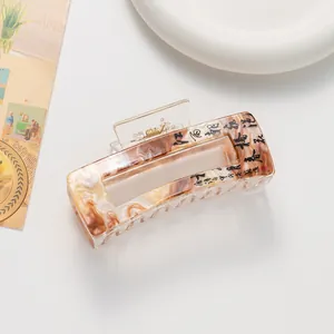 Detail of an amber acetate hair claw with Chinese calligraphy in New Chinese style