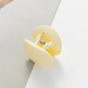 Close-up of matte cream yellow hair claw clip with durable metal spring detail