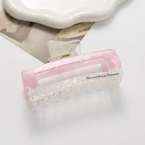 Detail of large iridescent rectangle hair claw clip with Barrette La France text