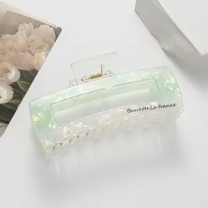 Macro shot of mint green iridescent rectangle hair claw with Barrette La France text