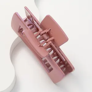 Macro shot of large hollow square claw clip in dusty rose with metallic finish texture