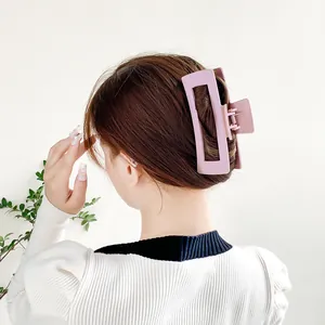 Large 12cm dusty pink matte hair claw clip for thick hair shown on a female model