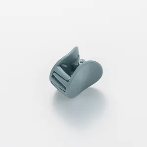 Detail view of a matte grey-blue hair claw clip with multi-tooth design and metal spring