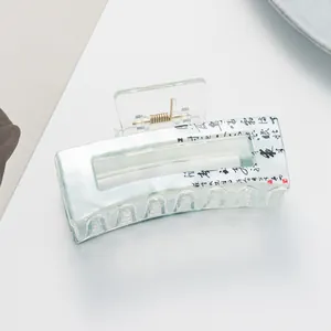 Detail of teal marbled acetate hair claw clip with black Chinese calligraphy art