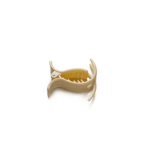 Creamy beige plastic shark hair claw clip with ergonomic curved design on white background
