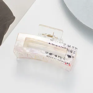 Detail of marble-textured acetate hair claw clip with Chinese calligraphy and red seal