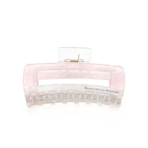 Detail of large marble texture hair claw clip with Barrette La France gold lettering