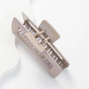 Detail view of a 12cm khaki matte rectangle claw clip with a strong metal spring mechanism