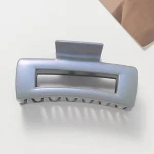 Macro detail of glossy blue-grey square hair claw clip with metallic pearl finish