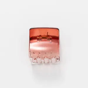 Close-up of a square translucent amber hair claw clip with a durable metal spring