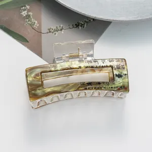 Detail view of retro green marble hair claw clip with Chinese calligraphy and gold accents