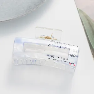 Close-up of marble pattern hair claw clip with Chinese calligraphy and red seal detail