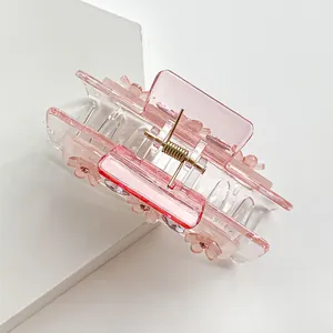 Pink translucent floral hair claw clip with rhinestones and elegant gold spring