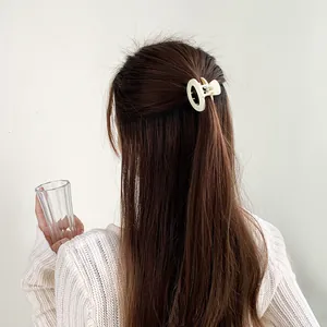 Cremeweiße ovale Haarspange im minimalistischen Look für eine halboffene Frisur