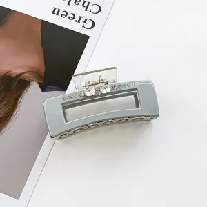 Detail of grey square hair claw clip featuring sparkling rhinestones and spring mechanism