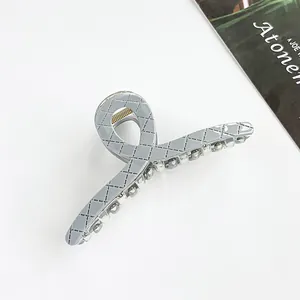 Macro detail of 13cm light grey quilted pattern hair claw clip with crystal bead trim
