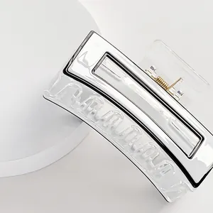 Minimalist square hair claw clip in translucent white with silver trim and metal spring