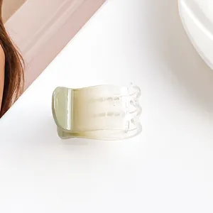 Detailed view of a gradient light green hair claw clip with a semi-transparent resin finish