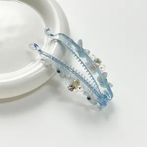 Barrette banane bleue translucide avec décor floral en résine et strass brillants