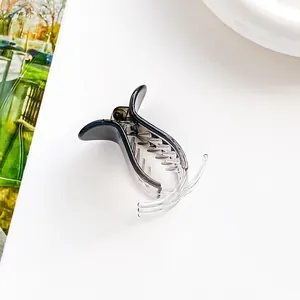 Detailed side view of a gradient grey hair claw clip on a clean white surface