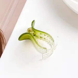 Detailed view of large green gradient hair claw clip with strong grip teeth