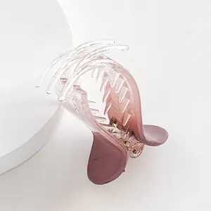 Elegant candy-colored gradient hair claw clip for high ponytail styling on a white stand
