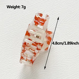 Mini acetate hair claw clip with amber marble pattern 4.8cm length for half-up hairstyles