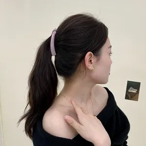 Pale purple banana hair clip for thin hair ponytail styling on model wearing black top