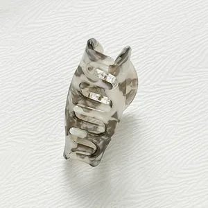 Detail of eco-friendly acetate hair claw clip with marble texture and metal spring