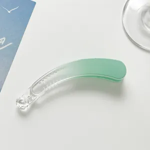 Macro detail of gradient mint green banana clip with anti-slip teeth and resin finish