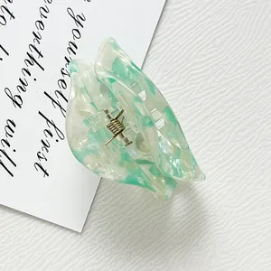 Eco-friendly semi-circle acetate hair claw with green and white marble texture
