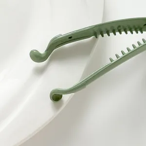 Glossy light green plastic banana clip with smooth round teeth for thin hair styling
