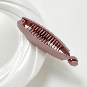 Detail view of the dense non-slip teeth inside the matte dusty rose banana hair clip