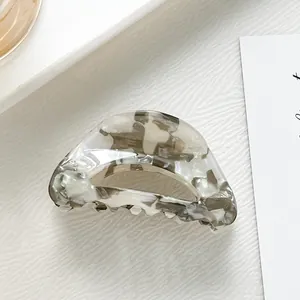 Close-up of marble pattern acetate hair claw clip for kids with smooth glossy finish
