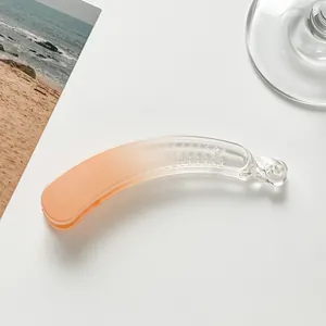 Detail of orange gradient seamless banana hair clip with internal fixing teeth
