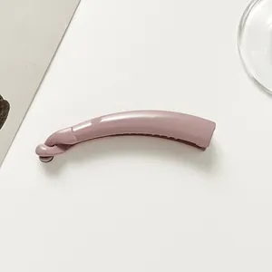 Detailed view of a mauve banana hair clip with a smooth glossy finish and secure twist lock