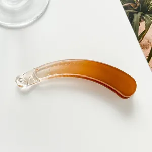 Detail of banana hair clip with amber gradient effect and internal non-slip teeth