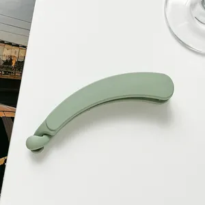 Detailed close-up of matte green banana hair clip with secure anti-slip locking mechanism